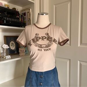 vintage-inspired brown and cream cowgirl graphic baby tee with a retro vibe